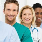 Group Of Happy Successful Doctors Standing In A Row At Hospital